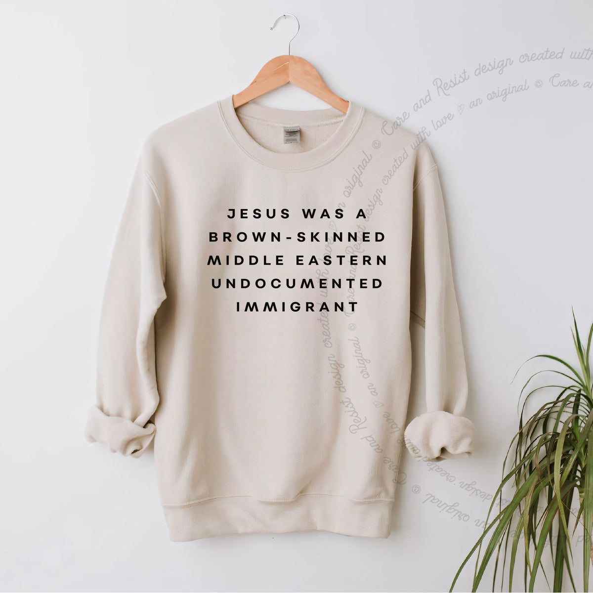 Jesus Was a Brownskinned Middle Eastern Undocumented Immigrant Care & Resist Gildan crewneck sweatshirt in Sand