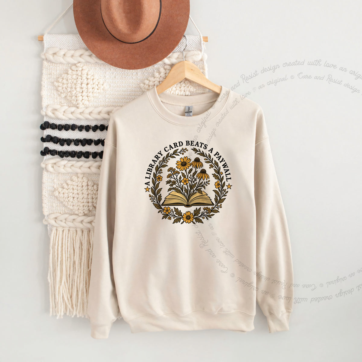 A Library Card Beats a Paywall Badge Care & Resist Gildan crewneck sweatshirt in Sand