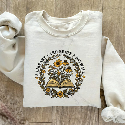 A Library Card Beats a Paywall Badge Care & Resist Gildan crewneck sweatshirt in Sand