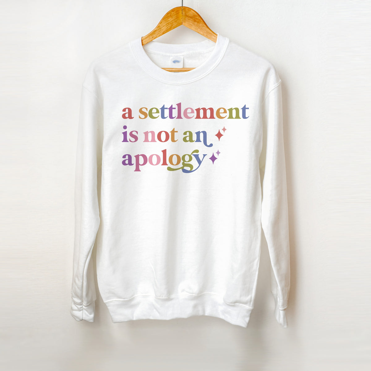 A Settlement is not an Apology Care & Resist Gildan crewneck sweatshirt in White