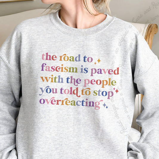 The Road to Fascism Is Paved With the People You Told to Stop Overreacting Care & Resist Gildan crewneck sweatshirt in Sport Grey