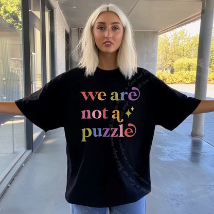 We are not a Puzzle Care & Resist rainbow tee