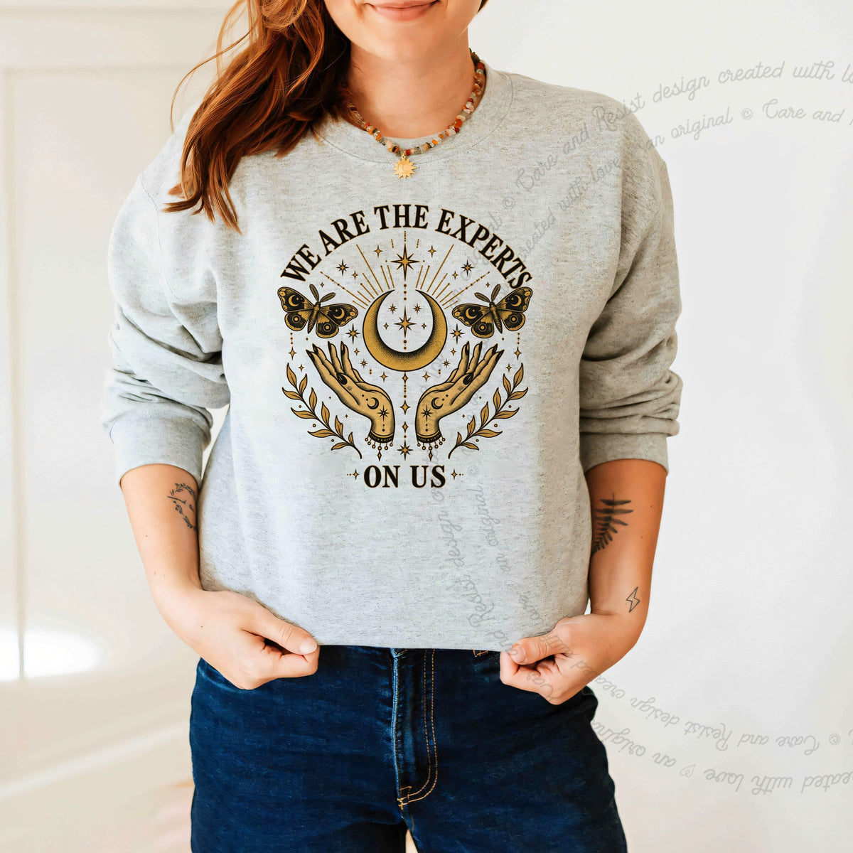 We are the Experts on Us Celestial Care & Resist Gildan crewneck sweatshirt in Sport Grey