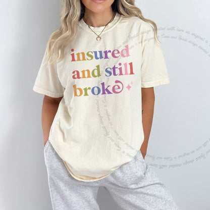 Insured and Still Broke Care & Resist rainbow Comfort Colors tee, Ivory