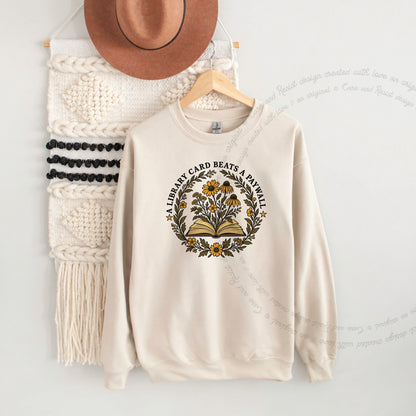 A Library Card Beats a Paywall Badge Care & Resist Gildan crewneck sweatshirt in Sand
