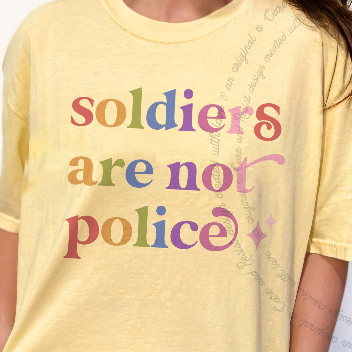 Soldiers are not Police Care & Resist progressive t-shirt in Banana