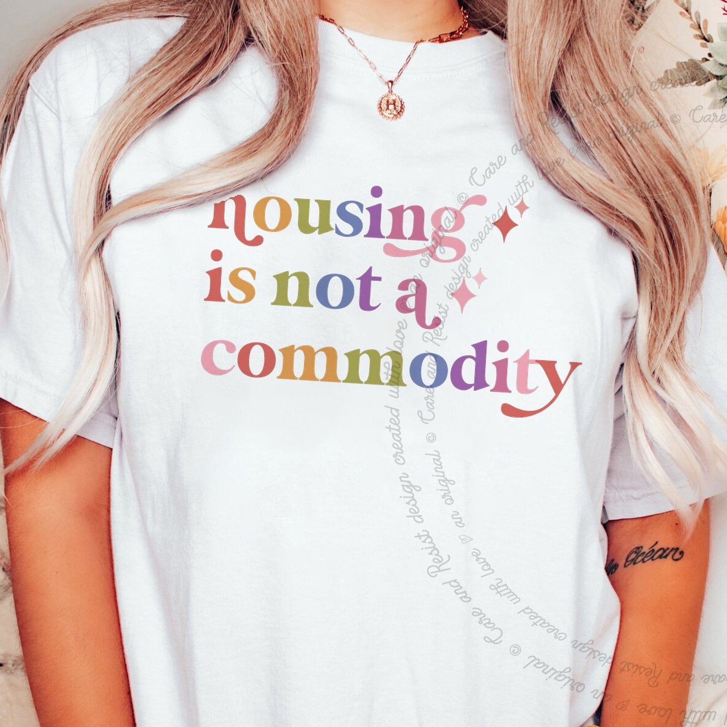 Housing is not a Commodity Care & Resist rainbow Comfort Colors tee, White