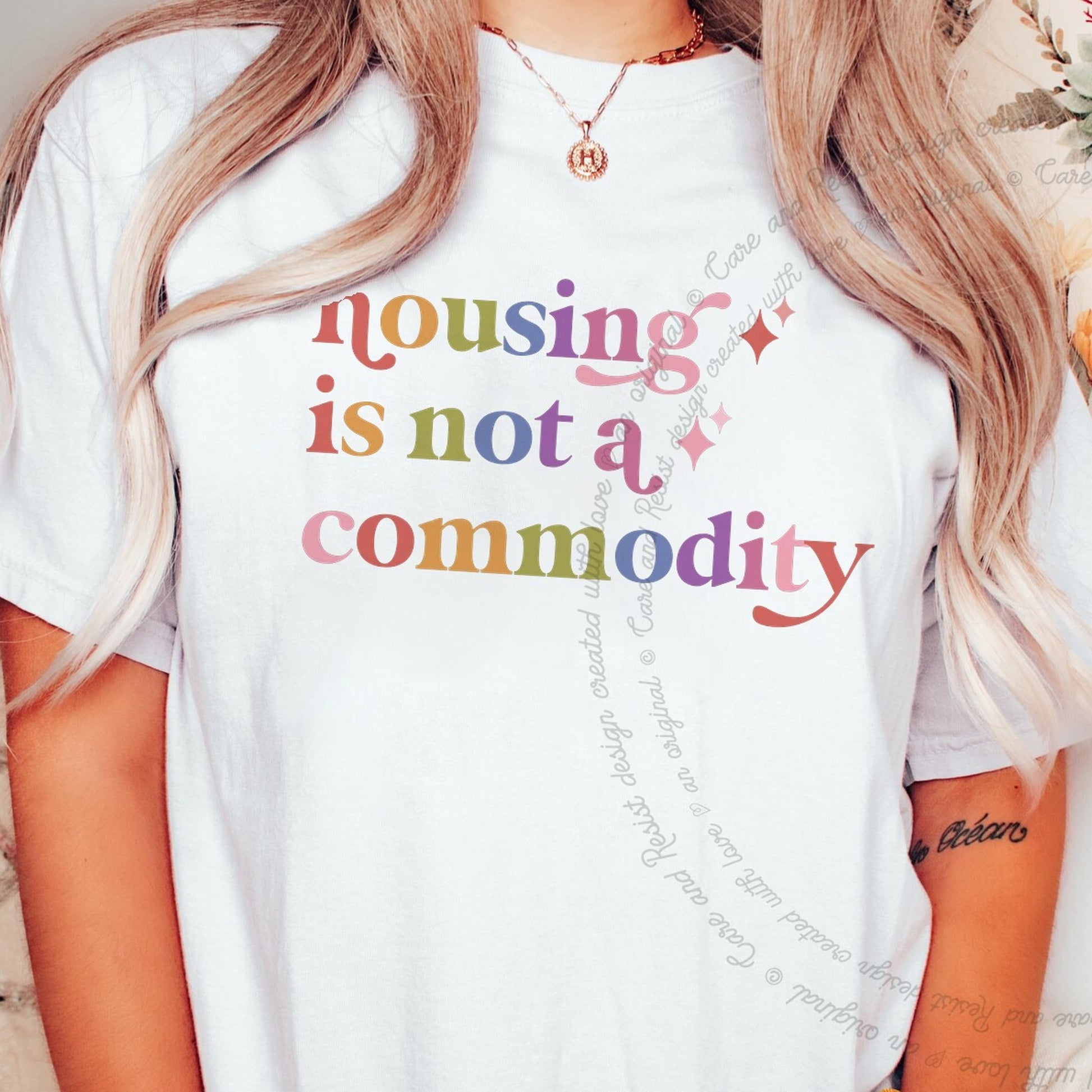 Housing is not a Commodity Care & Resist rainbow Comfort Colors tee, White