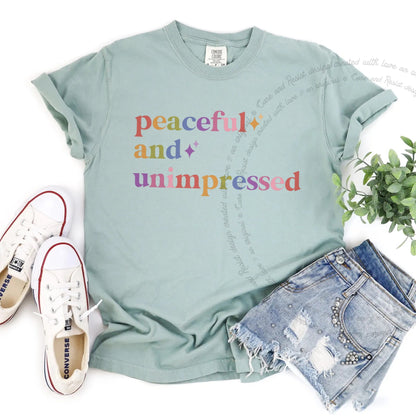 Peaceful and Unimpressed Care & Resist rainbow tee