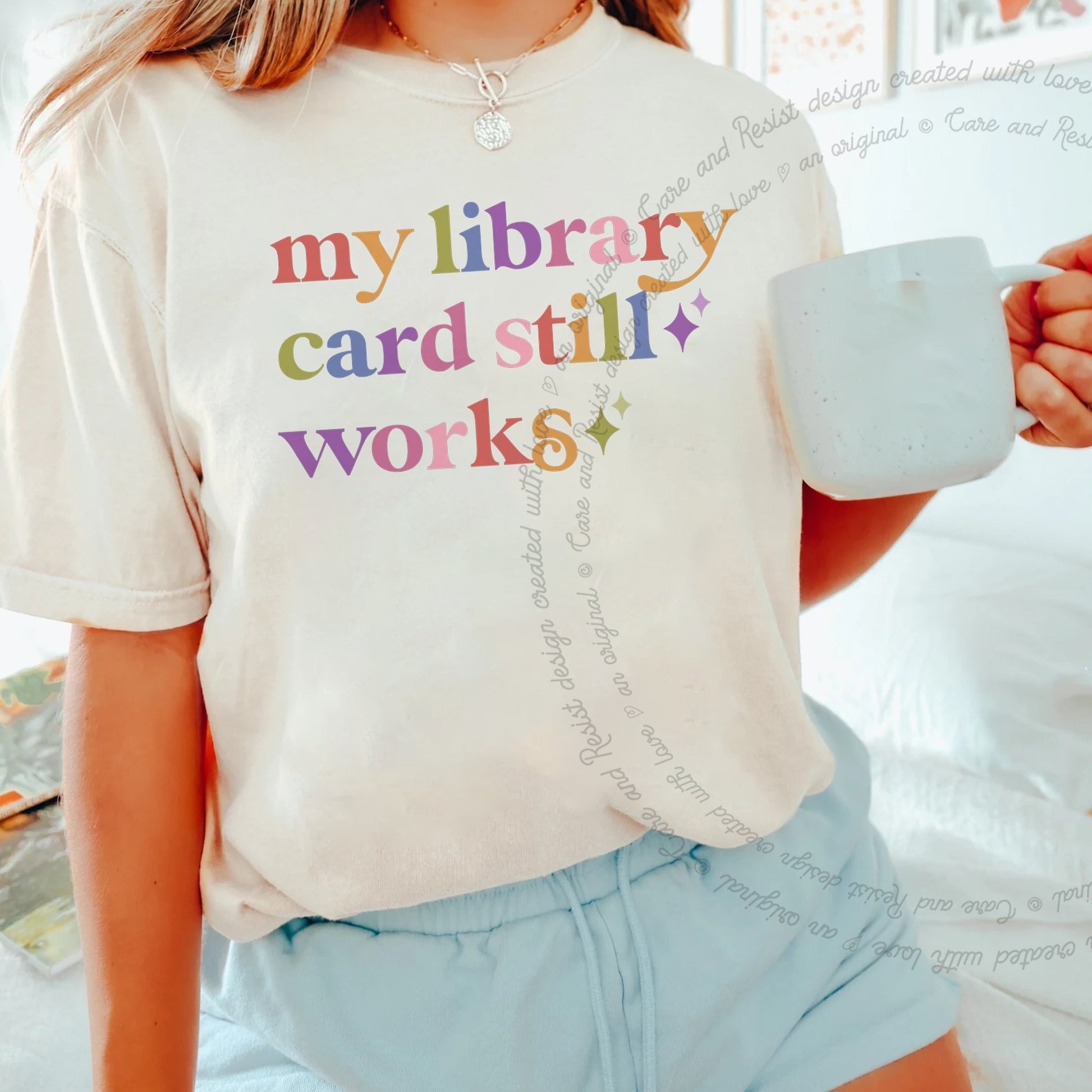 My Library Card Still Works Care & Resist rainbow Comfort Colors tee, Ivory
