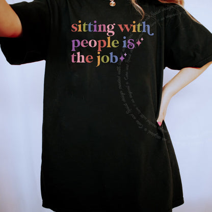 Sitting With People is the Job Care & Resist rainbow Comfort Colors tee, Black