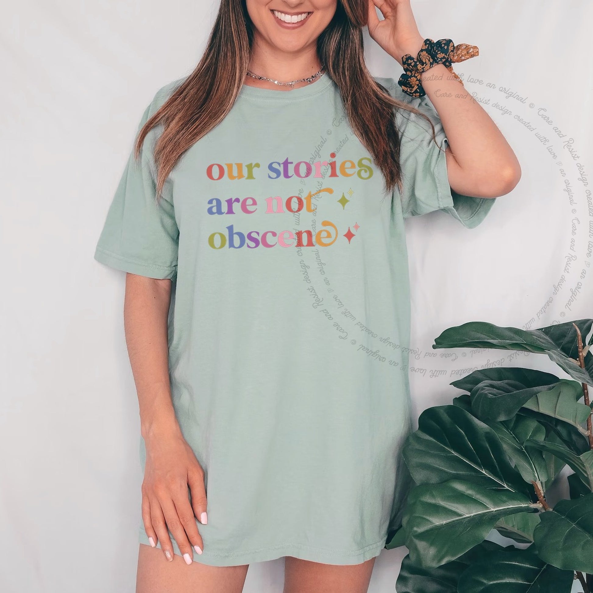 Our Stories are not Obscene Care & Resist rainbow Comfort Colors tee, Bay