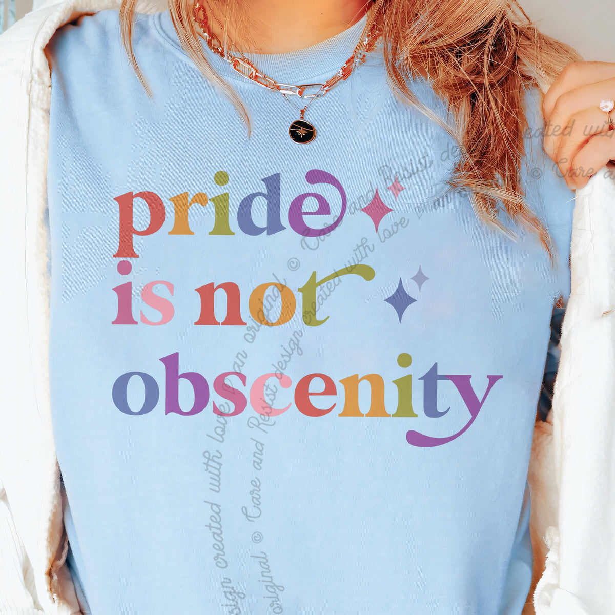 Pride is not Obscenity Care & Resist tee in Chambray, close-up of the lettering