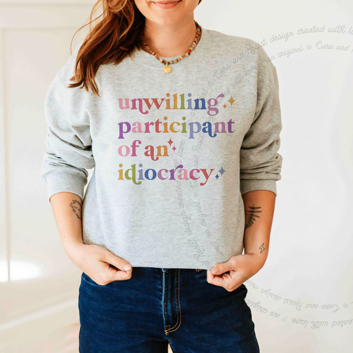 Unwilling Participant of an Idiocracy Care & Resist Gildan crewneck sweatshirt in Sport Grey
