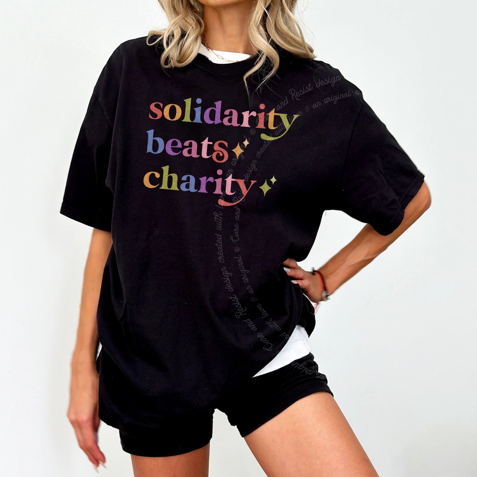 Solidarity Beats Charity Care & Resist rainbow tee