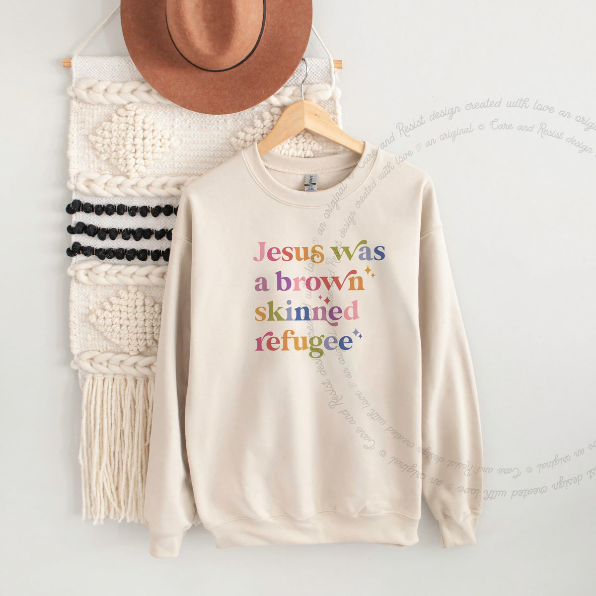 Jesus Was a Brown Skinned Refugee Care & Resist Gildan crewneck sweatshirt in Sand