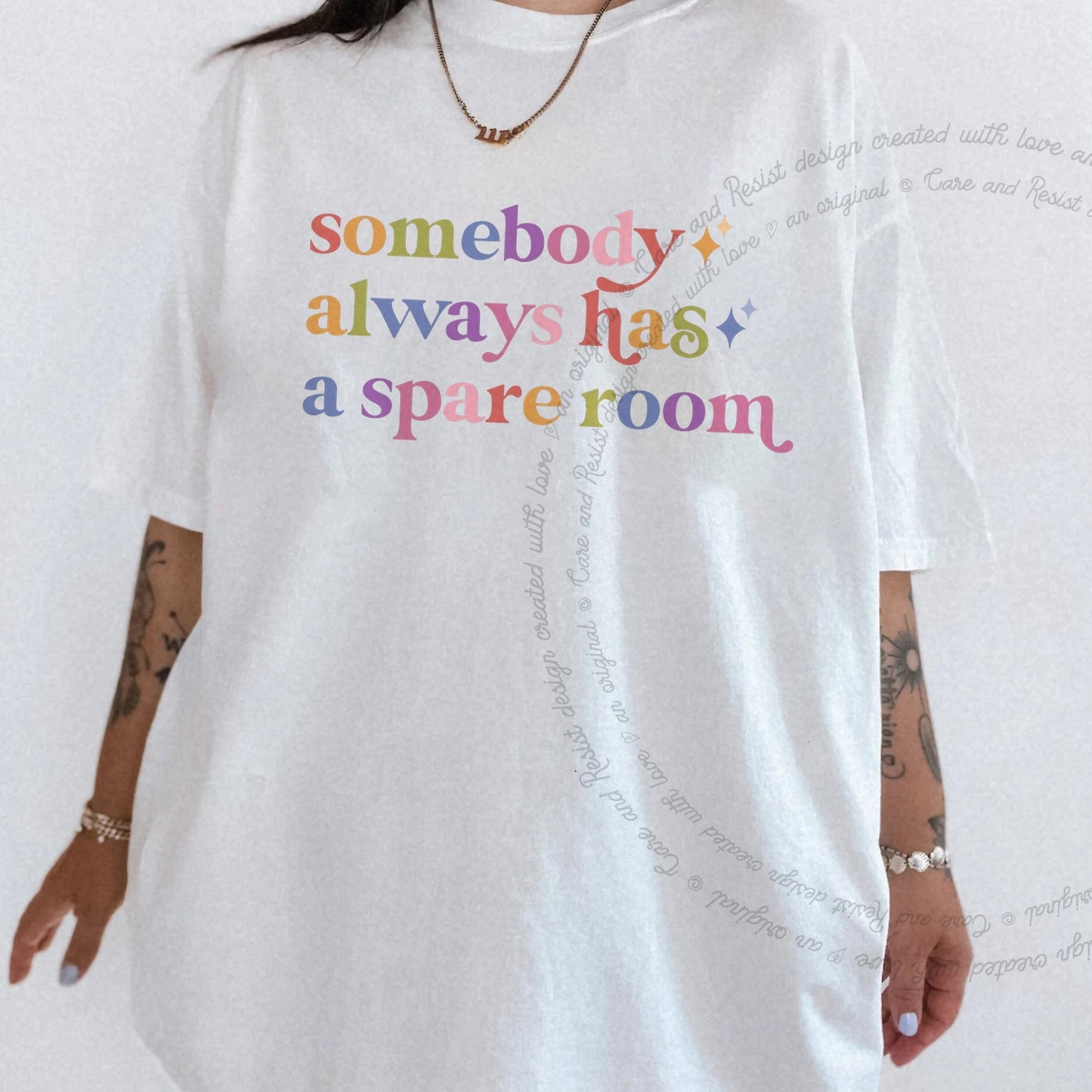 Somebody Always Has a Spare Room Care & Resist rainbow tee
