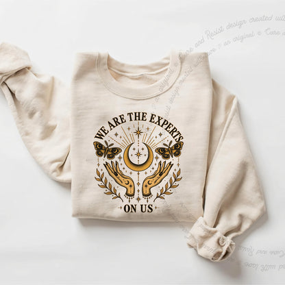 We are the Experts on Us Celestial Care & Resist Gildan crewneck sweatshirt in Sand