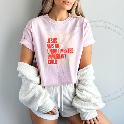 Jesus Was an Undocumented Immigrant Child Care & Resist progressive t-shirt in Blossom