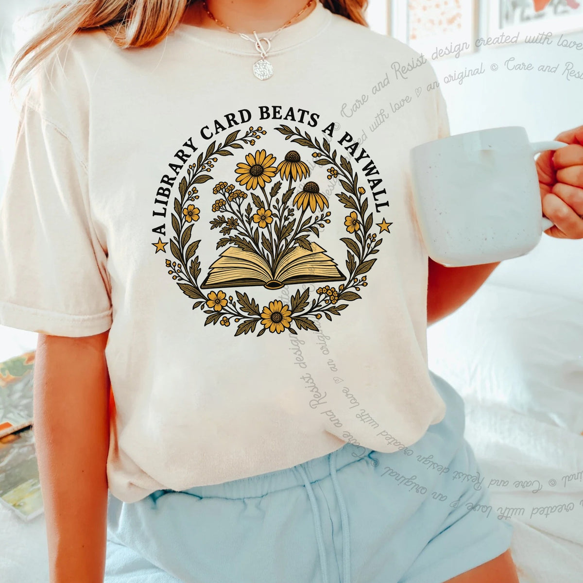 A Library Card Beats a Paywall Badge Care & Resist progressive t-shirt in Ivory