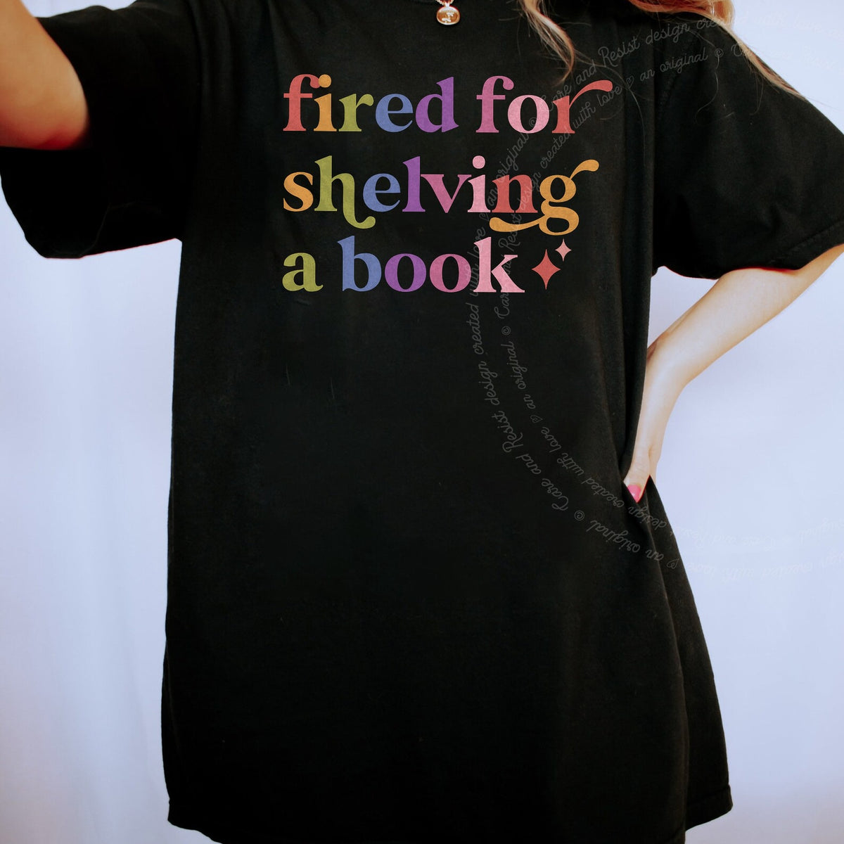 Fired for Shelving a Book Care & Resist rainbow tee
