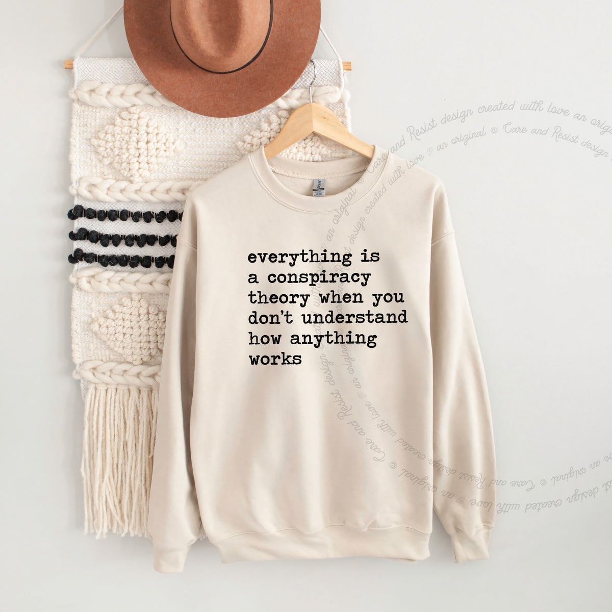 Everything Is a Conspiracy Theory When You Don't Understand How Anything Works Care & Resist Gildan crewneck sweatshirt in Sand