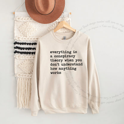 Everything Is a Conspiracy Theory When You Don't Understand How Anything Works Care & Resist Gildan crewneck sweatshirt in Sand
