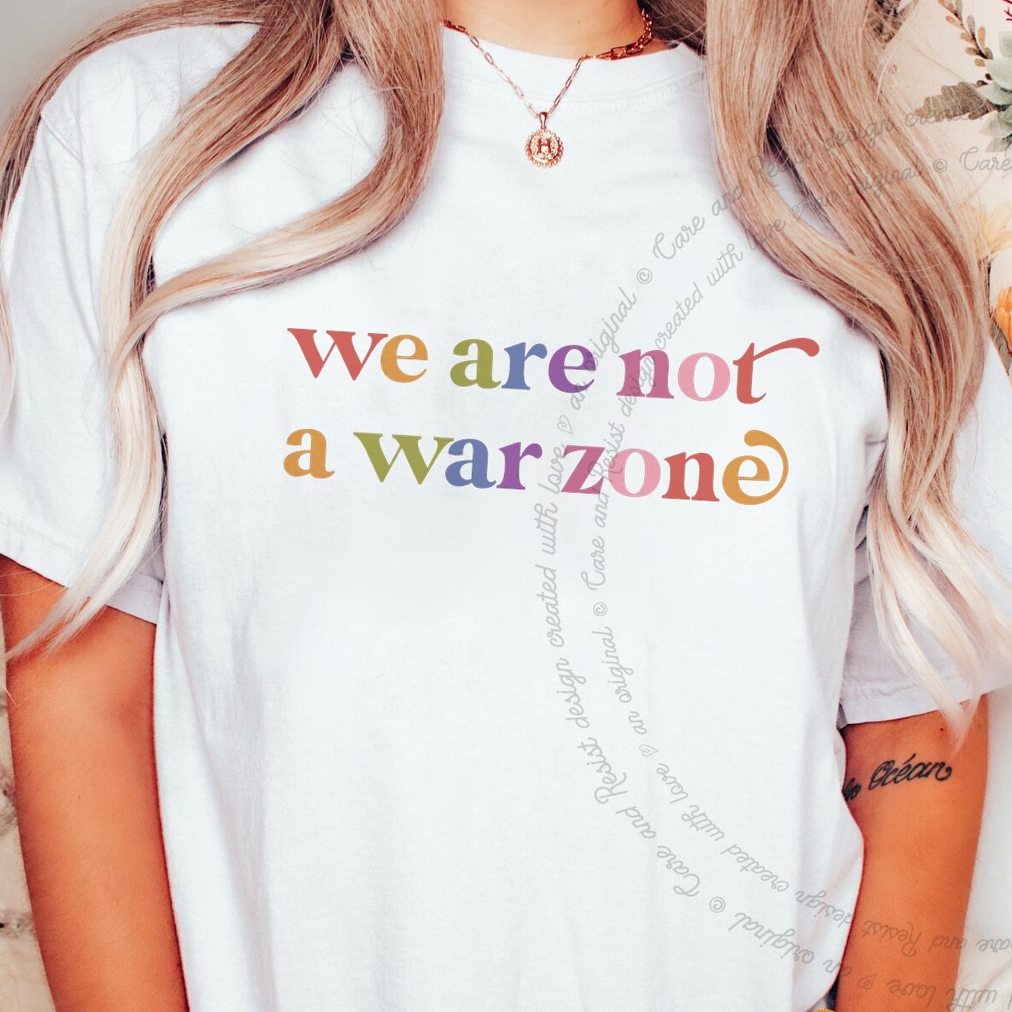 We are not a War Zone Care & Resist rainbow tee
