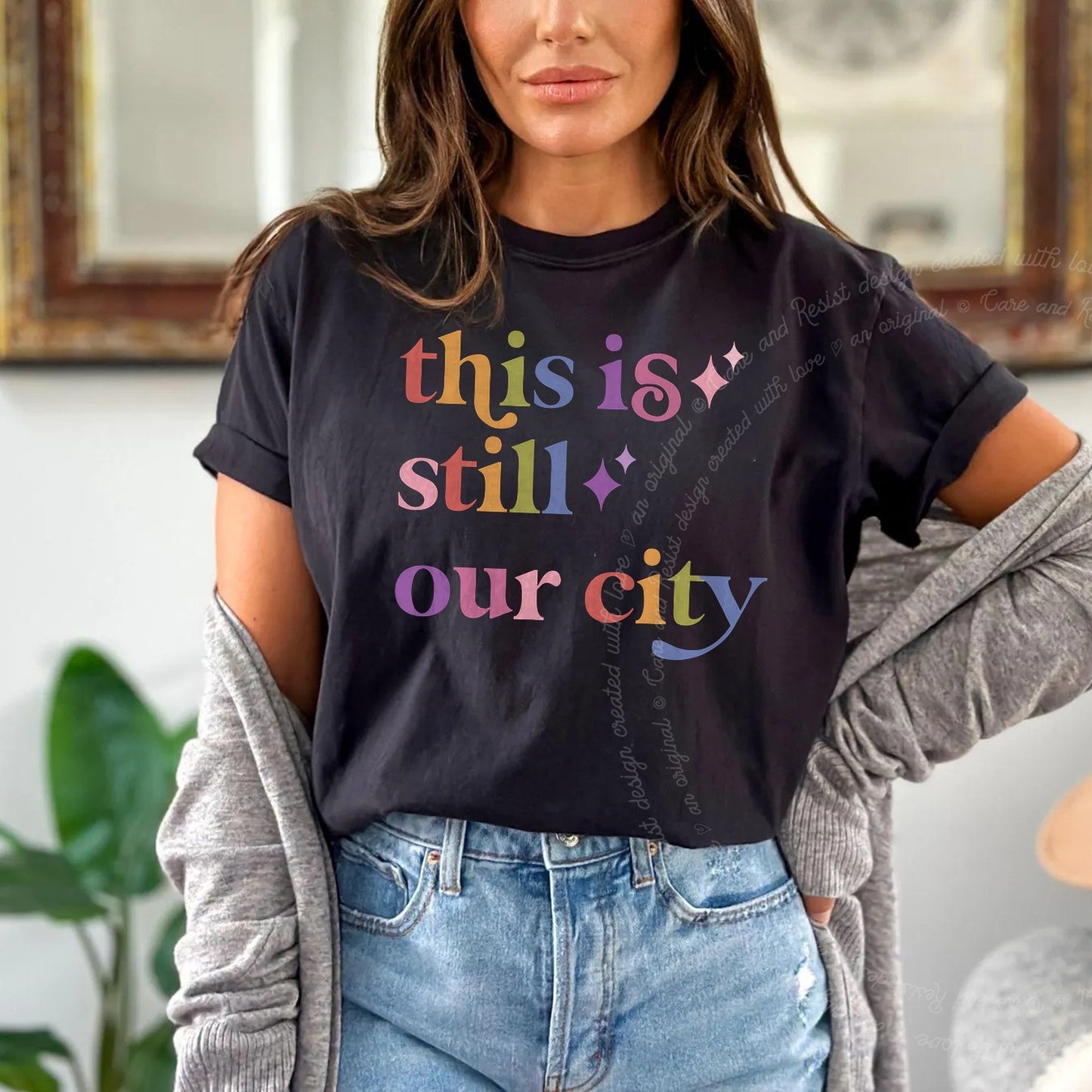 This is Still Our City Care & Resist rainbow tee