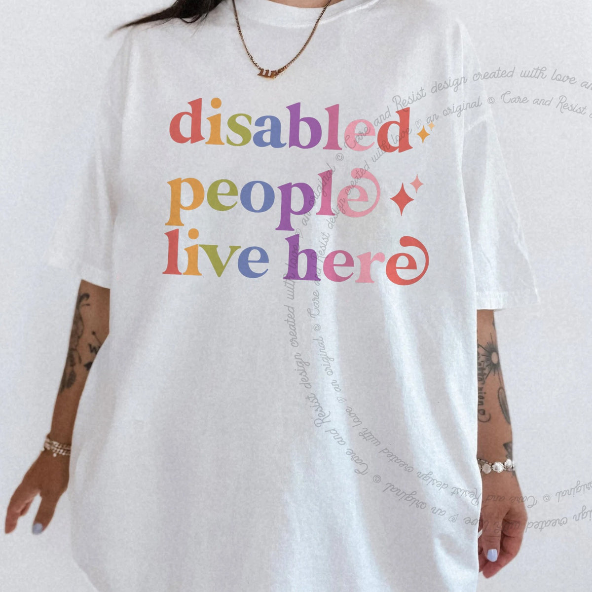 Disabled People Live Here Care & Resist rainbow tee