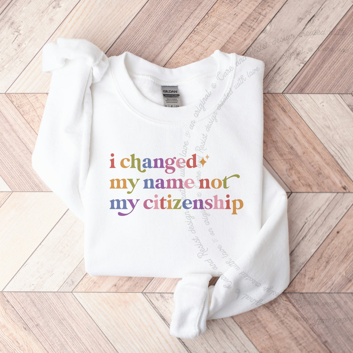 I Changed My Name not My Citizenship Care & Resist Gildan crewneck sweatshirt in White