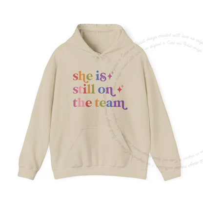 She is Still on the Team Care & Resist Gildan hoodie in Sand