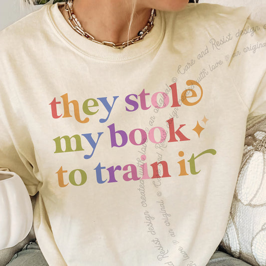 They Stole My Book to Train It Care & Resist progressive t-shirt in Ivory