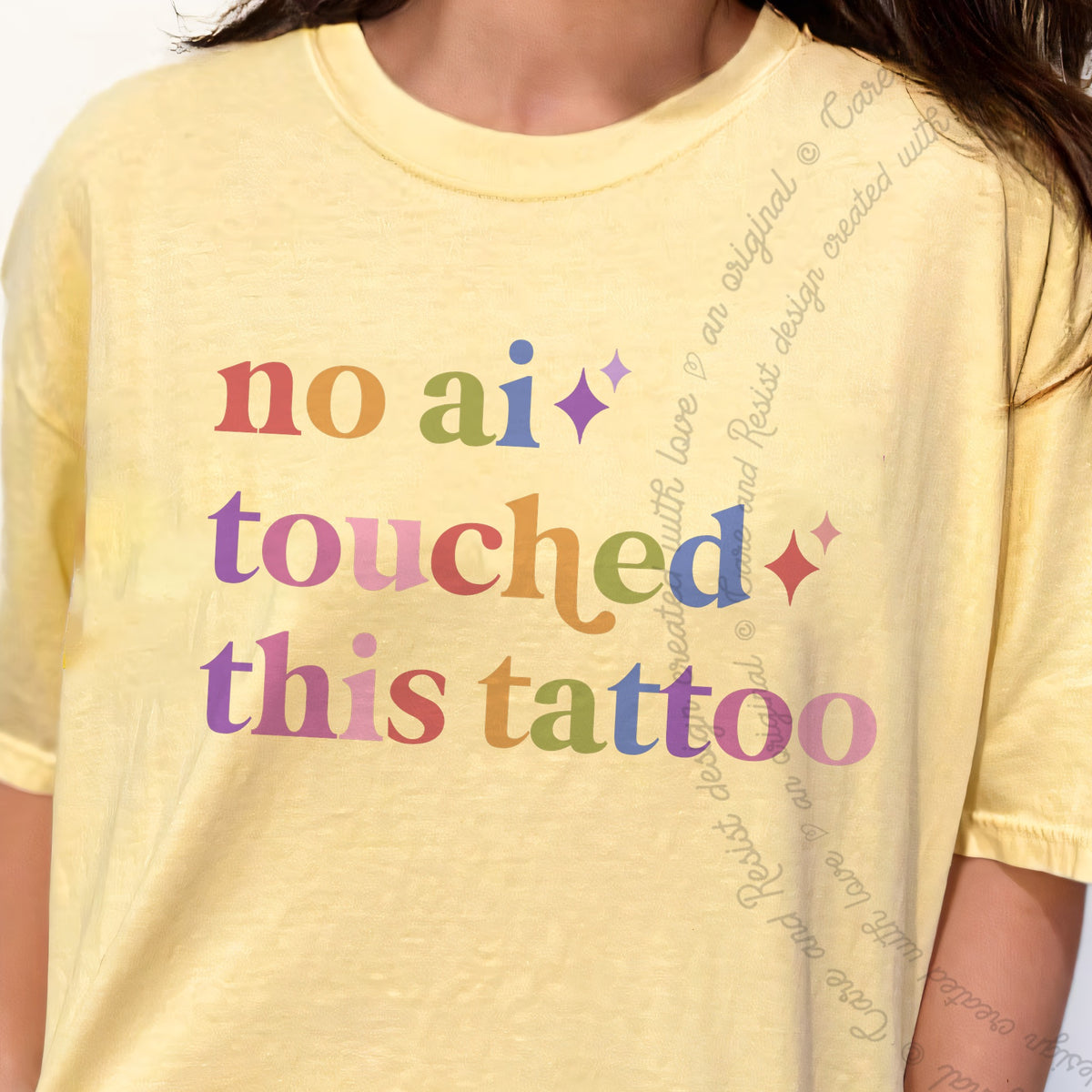 No Ai Touched This Tattoo Care & Resist tee in Banana, close-up of the lettering