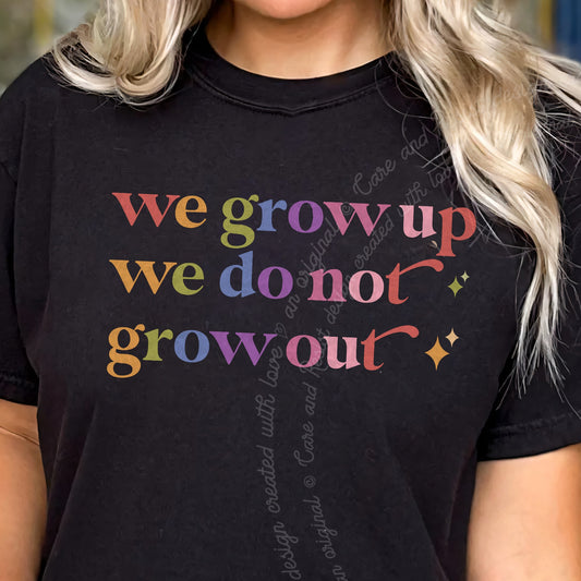 We Grow Up We Do not Grow Out Care & Resist tee in Black, close-up of the lettering