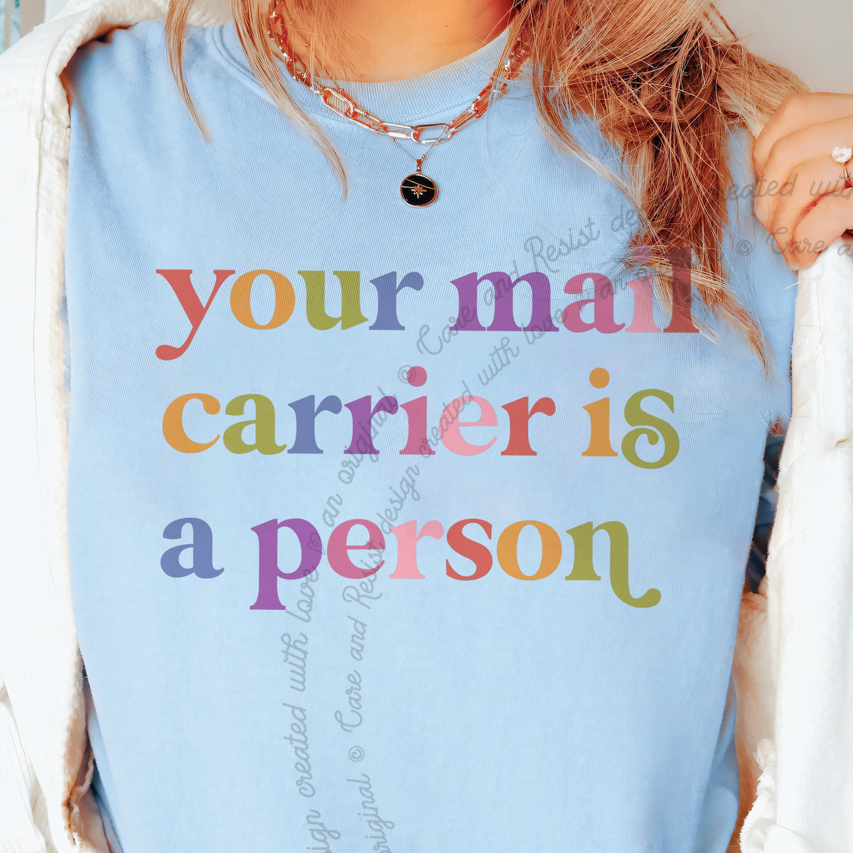 Your Mail Carrier is a Person Care & Resist tee in Chambray, close-up of the lettering