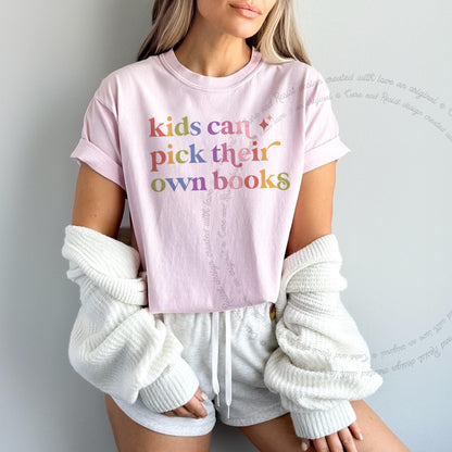 Kids Can Pick Their Own Books Care & Resist rainbow Comfort Colors tee, Blossom