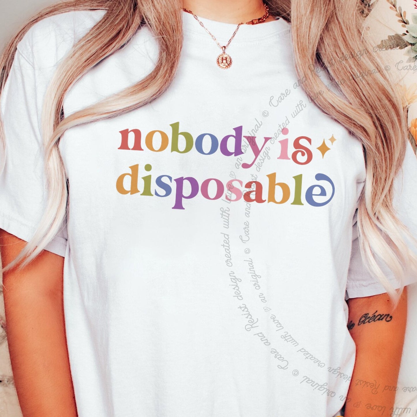 Nobody is Disposable Care & Resist rainbow tee