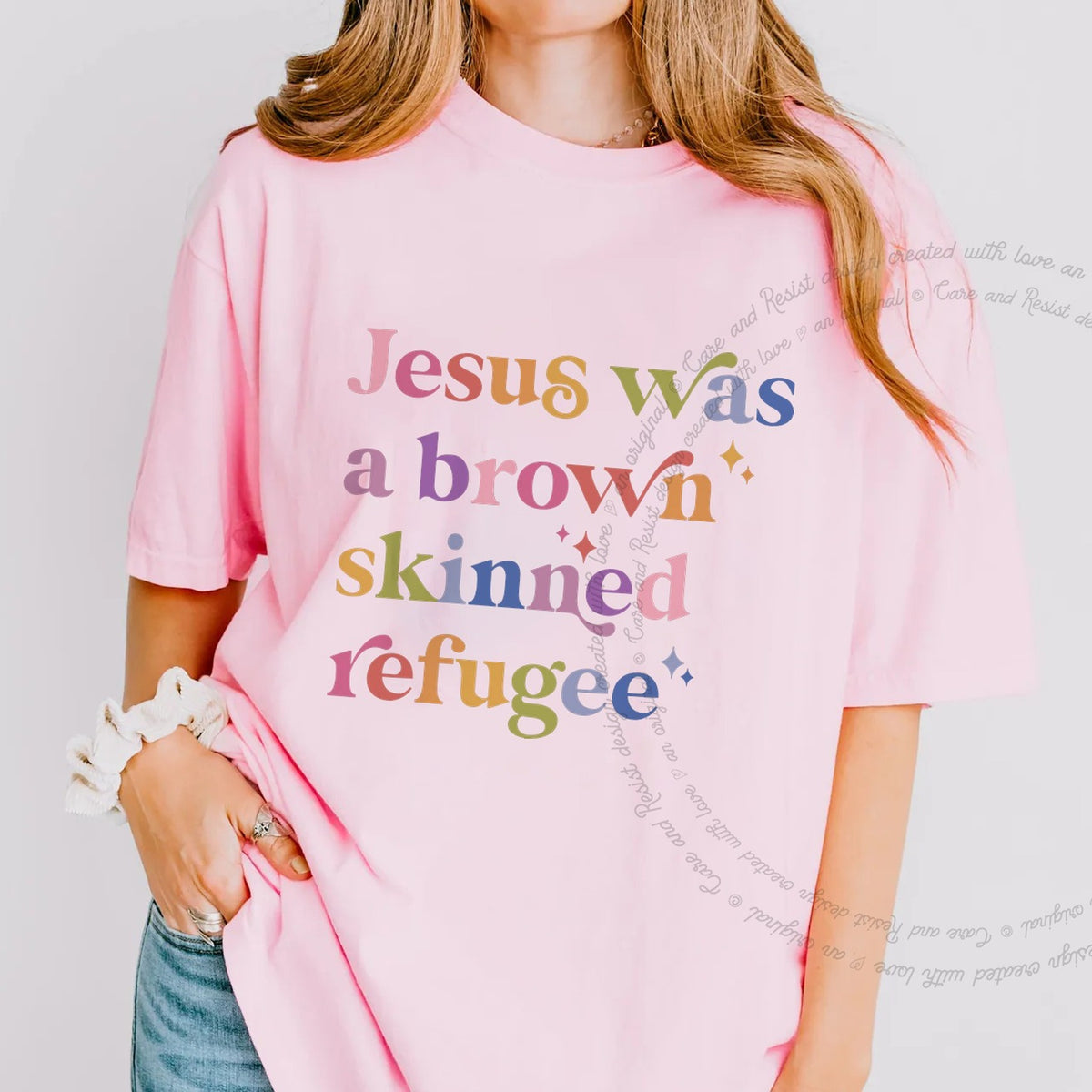 Jesus Was a Brown Skinned Refugee Care & Resist progressive t-shirt in Blossom