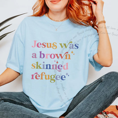 Jesus Was a Brown Skinned Refugee Care & Resist progressive t-shirt in Chambray