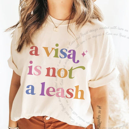 A Visa is not a Leash Care & Resist rainbow Comfort Colors tee, Ivory