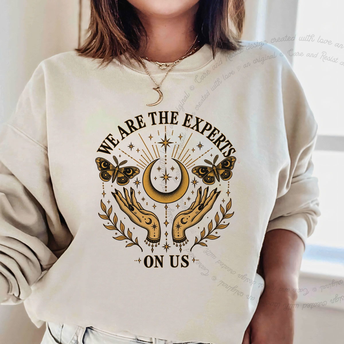 We are the Experts on Us Celestial Care & Resist Gildan crewneck sweatshirt in Sand