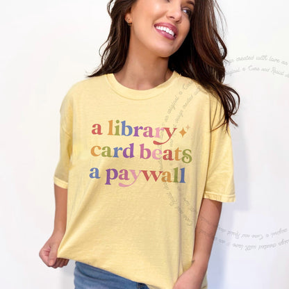 A Library Card Beats a Paywall Care & Resist rainbow tee