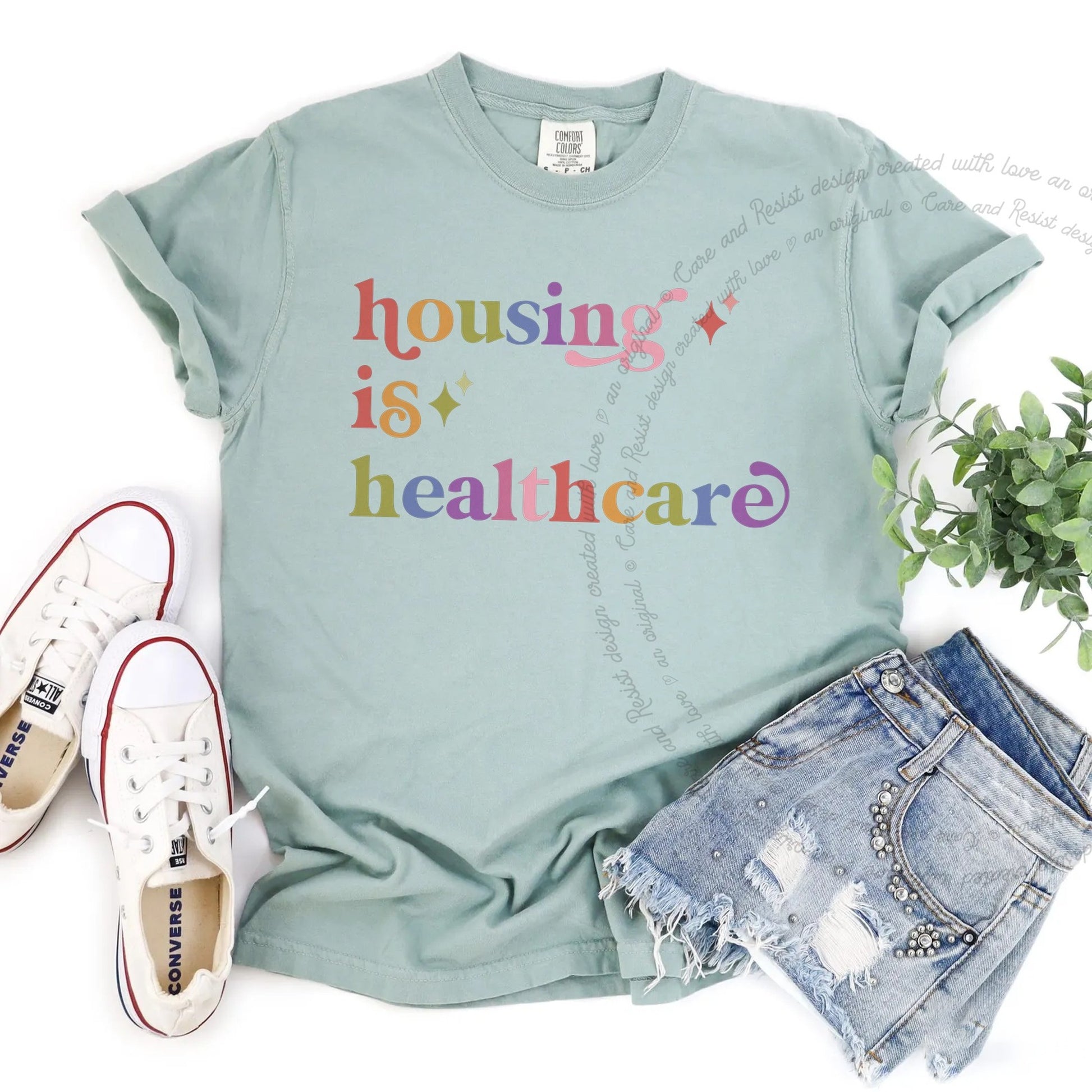 Housing is Healthcare Care & Resist rainbow Comfort Colors tee, Bay