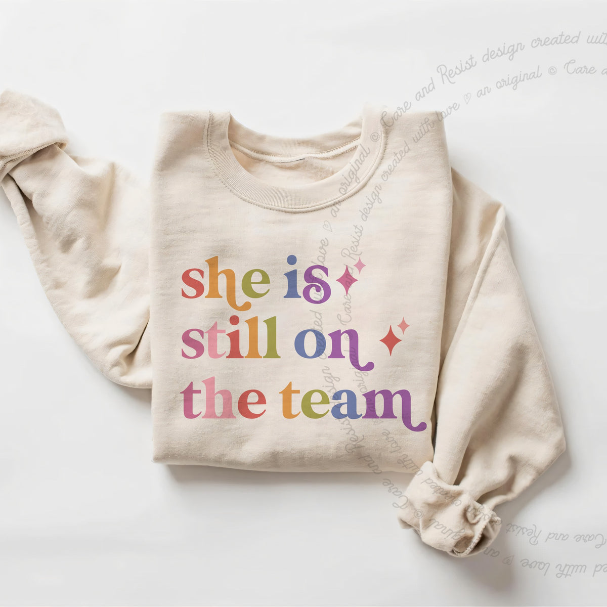 She is Still on the Team Care & Resist Gildan crewneck sweatshirt in Sand