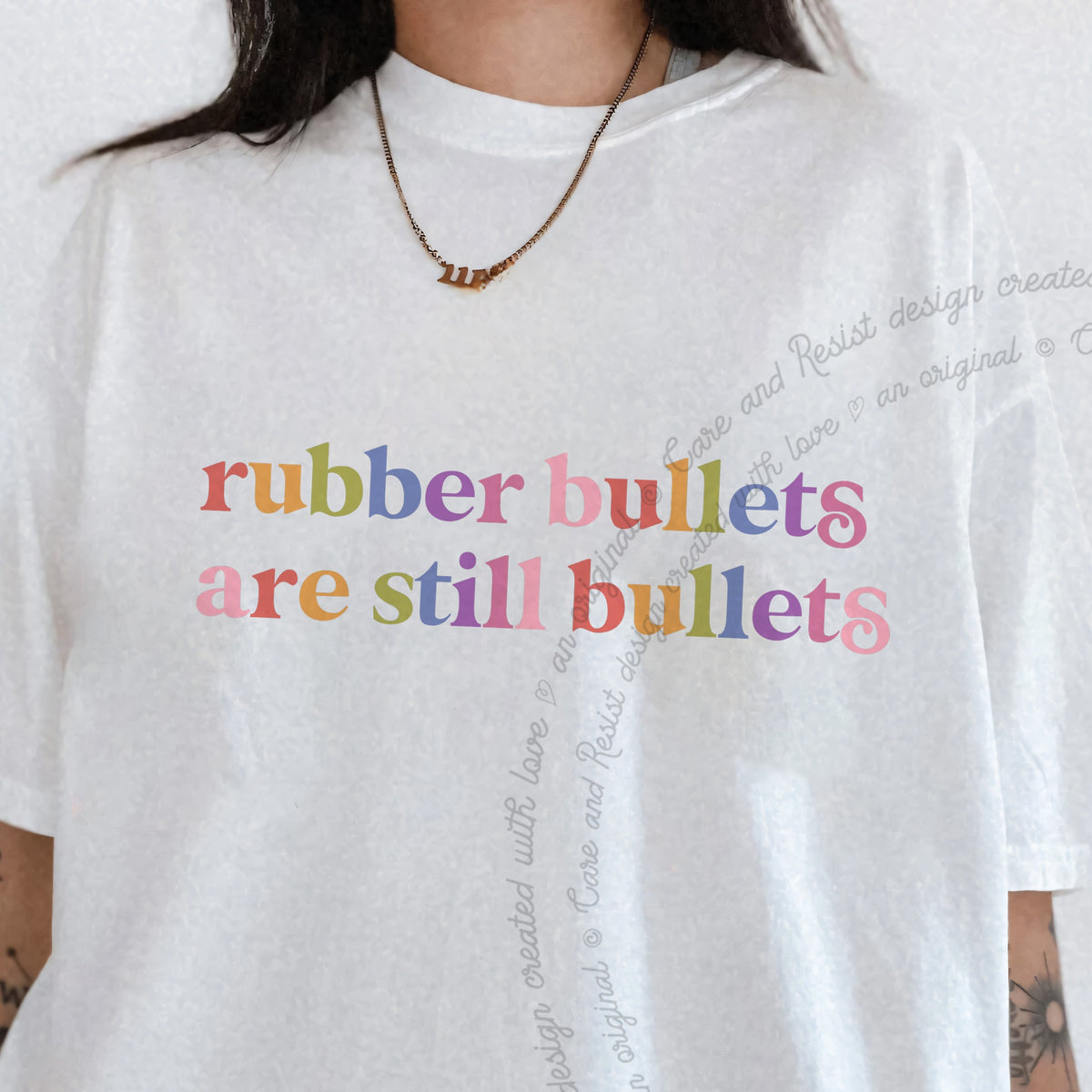 Rubber Bullets are Still Bullets Care & Resist progressive t-shirt in White