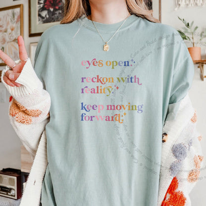 Eyes Open. Reckon With Reality. Keep Moving Forward. Care & Resist progressive t-shirt in Bay