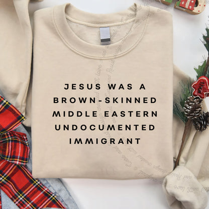 Jesus Was a Brownskinned Middle Eastern Undocumented Immigrant Care & Resist Gildan crewneck sweatshirt in Sand