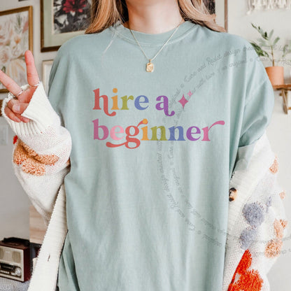 Hire a Beginner Care & Resist rainbow tee
