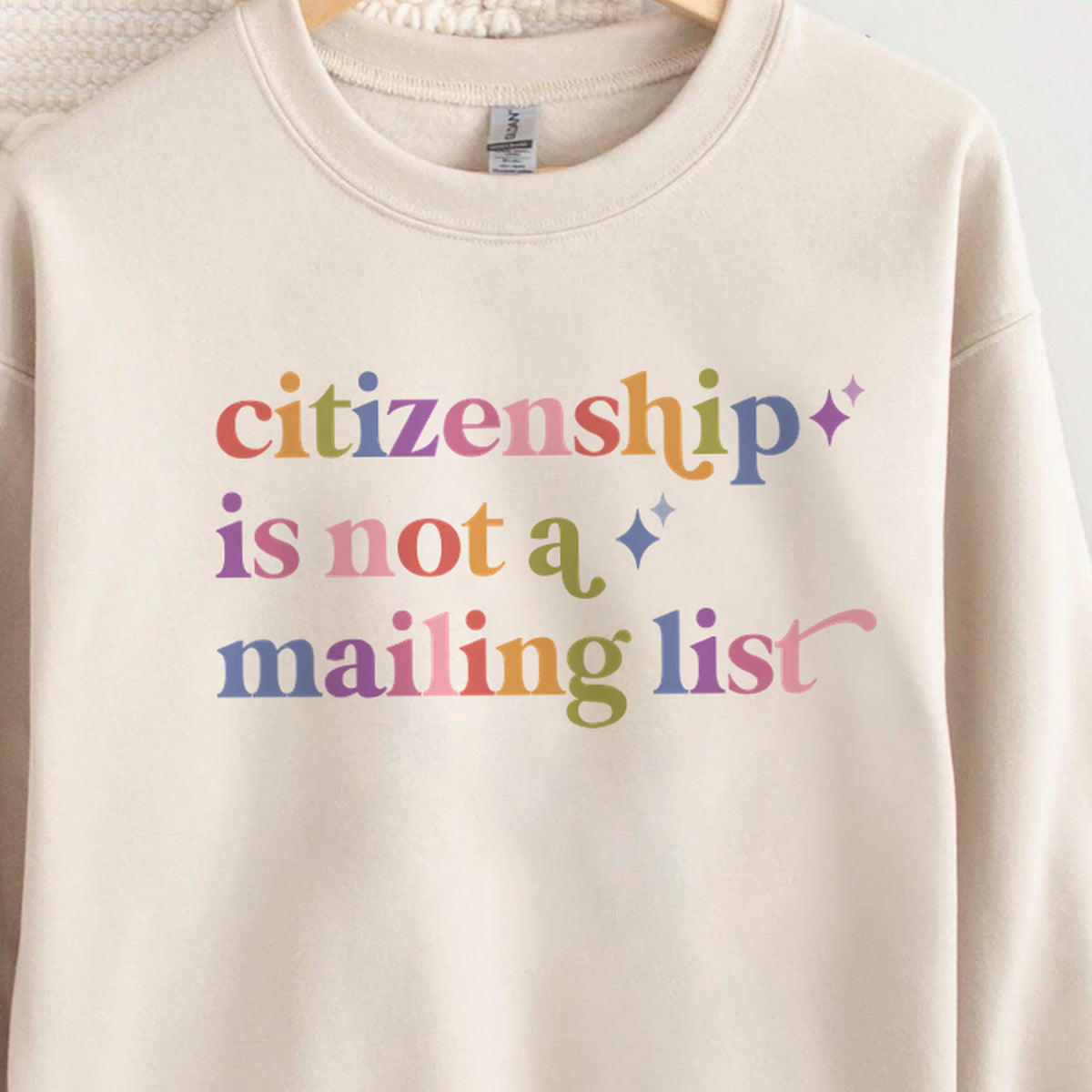 Citizenship is not a Mailing List Care & Resist Gildan crewneck sweatshirt in Sand